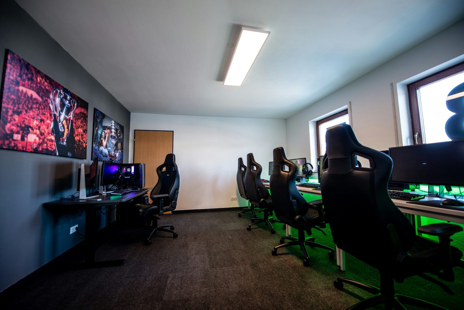 people sitting on office rolling chairs